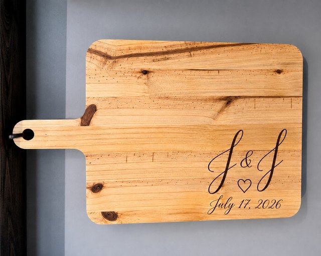 Wooden charcuterie board with J and J initials and a date laser engraved